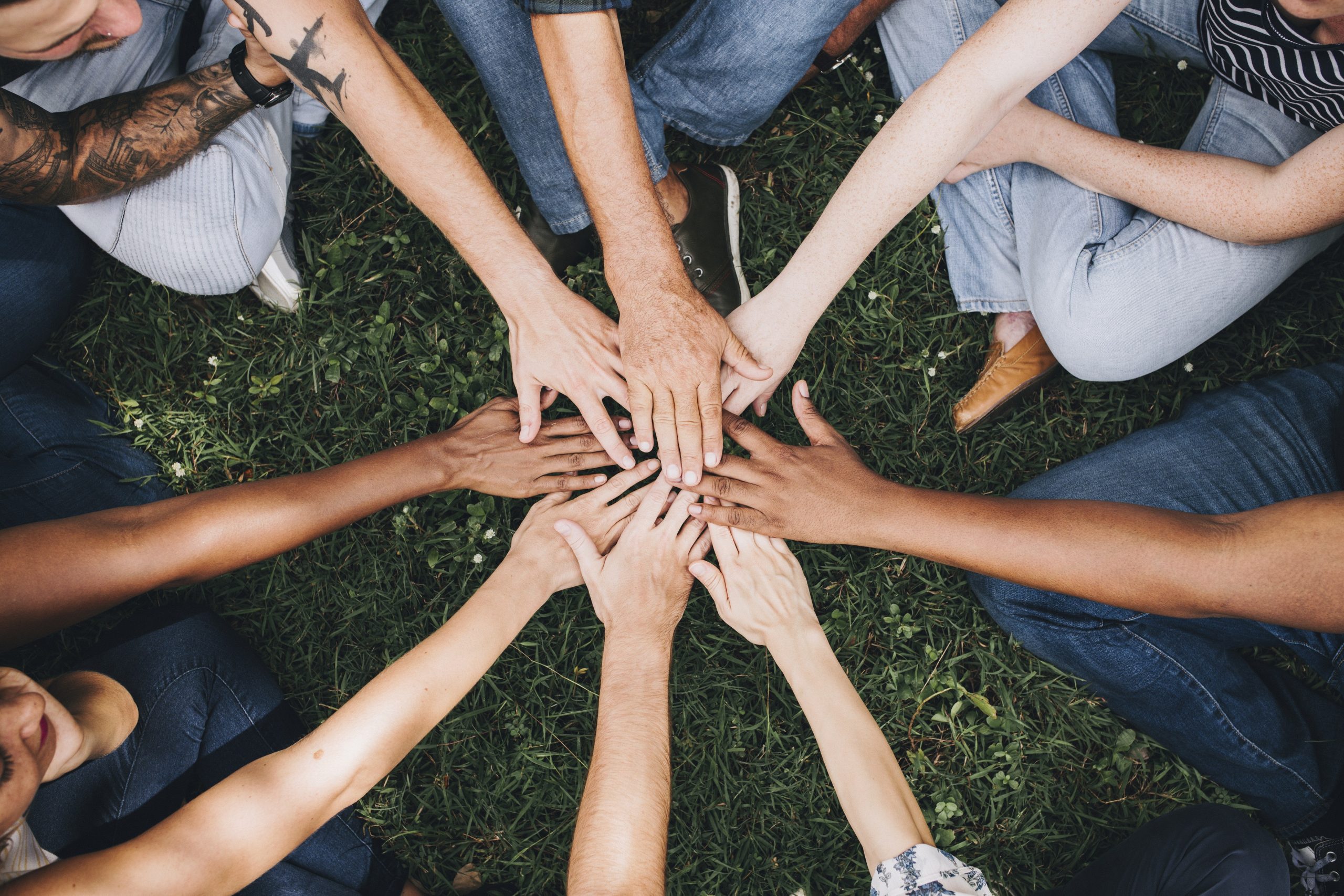 People stacking hands together in the park Immagine anteprima